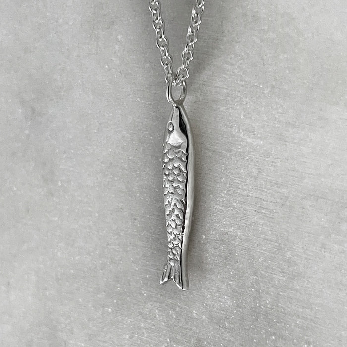 side view of our Silver fish Necklace, Sardine Necklace hanging on a 925 trace chain.