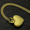 photo show the trace chain necklace of our solid 925 sterling silver heart pendant with a 24k gold vermeil finish.