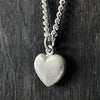 side view of our Solid 925 Sterling Silver three dimensional heart pendant on a curb chain.
