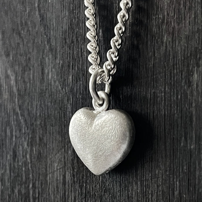 side view of our Solid 925 Sterling Silver three dimensional heart pendant on a curb chain.