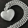 detail photo of our Solid 925 Sterling Silver three dimensional heart pendant necklace on a curb chain.