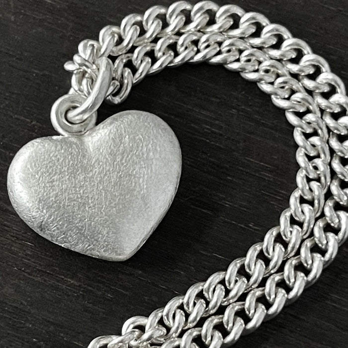 detail photo of our Solid 925 Sterling Silver three dimensional heart pendant necklace on a curb chain.