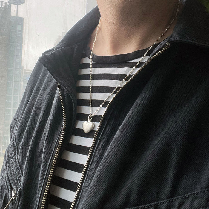photo of our Solid 925 Sterling Silver three dimensional heart pendant shown on a male model.