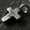 detail photo showing the texture on the rustic cross pendant.