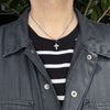 rustic cross pendant shown on a male model