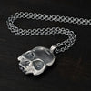 detail photo of this double-sided flat skull pendant showing the hallmark of London.