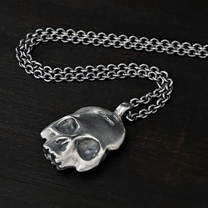 detail photo of this double-sided flat skull pendant showing the hallmark of London.