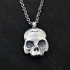 detail photo of the hallmark on this this double-sided flat skull pendant by jewel thief Brighton.