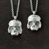 photo showing the two side to this double-sided flat skull pendant by jewel thief Brighton.