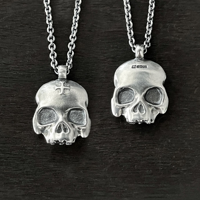 photo showing the two side to this double-sided flat skull pendant by jewel thief Brighton.