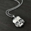 alternative photo of this double-sided flat skull pendant showing a cross on one side of the skull.