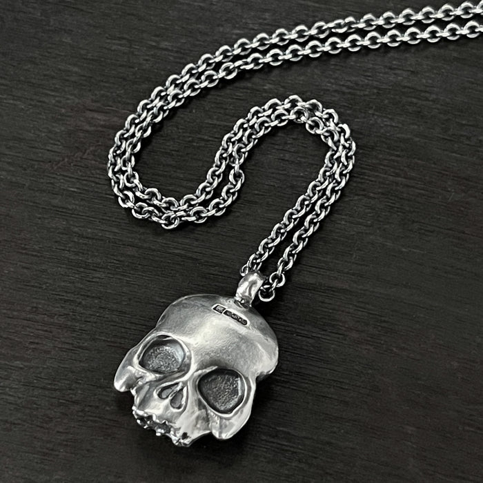 hallmarked side to this double-sided flat skull pendant by jewel thief Brighton.