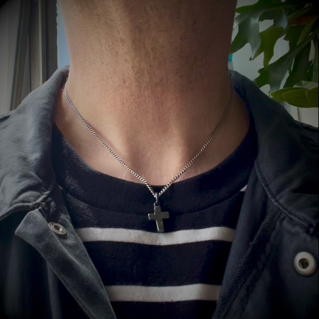 rustic chubby cross pendant necklace on a male model by jewel thief Brighton.