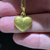 video of our solid 925 sterling silver heart pendant with a 24k gold vermeil finish showing the texture on the pendant.