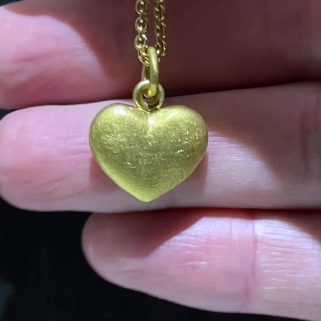 video of our solid 925 sterling silver heart pendant with a 24k gold vermeil finish showing the texture on the pendant.