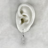 silver  sardine fish hook earrings shown on a  model of the ear.