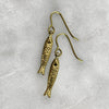 photo showing the fish scales of the gold sardine fish hook earrings by jewel thief Brighton.