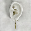 gold sardine fish hook earrings shown on a model of the ear.