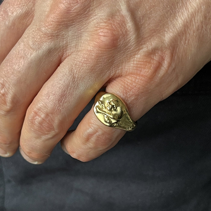 gold skull and crossbones ring on model